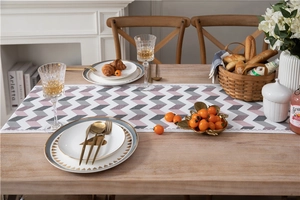 Macro detail of chevron pattern chenille table runner with delicate white lace edges