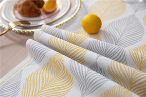 Macro shot of jacquard leaf pattern fabric with yellow and grey details on a table runner
