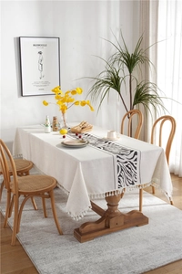 Macro detail of rectangle cotton linen tablecloth featuring zebra stripes and white tassels