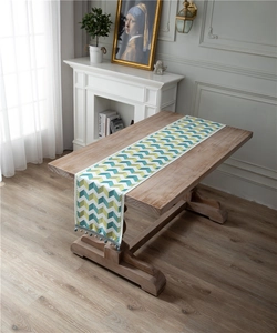 Detail of chenille table runner with jacquard wave patterns and elegant blue bead tassels
