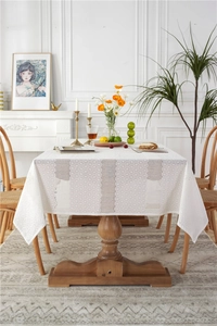 Detailed macro of white lace tablecloth with hollow patterns and dot embroidery texture