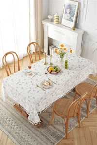 Close-up of lilac cotton jacquard tablecloth featuring delicate white fringe tassel edges