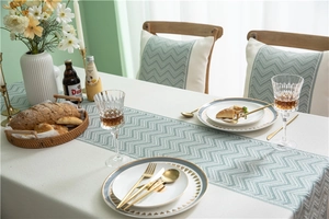 Close-up of sage green zigzag jacquard table runner and matching chair back covers