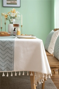 Close-up of herringbone pattern and woven tassels on a mint green spliced tablecloth