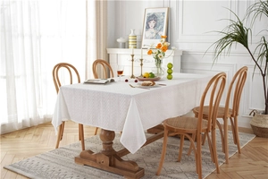 Close-up of white镂空lace tablecloth with vintage geometric embroidery on wood table