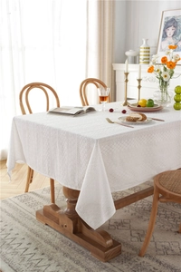 Close-up of white cotton lace tablecloth with geometric hollow crochet embroidery detail