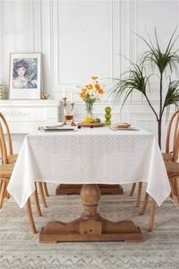 Close-up of white cotton lace tablecloth with vintage floral hollow embroidery