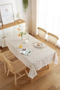 Macro detail of floral polyester-cotton tablecloth with intricate white lace border trim