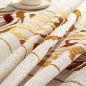 Linen table runner with orange tiger stripe embroidery and elegant tassel detail