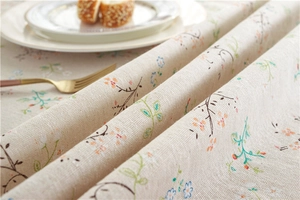 Detail of floral poly-cotton tablecloth with rose lace edge and textured fabric
