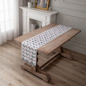 Nordic jacquard chenille table runner with pink geometric patterns and blue tassels