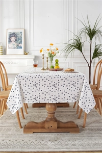Close-up of cotton jacquard fabric showing blue sunflower patterns on a white tablecloth