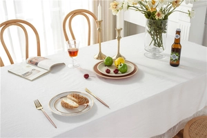 Close-up of white washed cotton tablecloth featuring elegant meteor shower lace edges