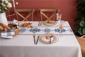 Detail of Mediterranean cotton linen tablecloth with blue tile pattern on white fabric