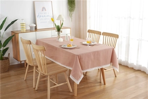 Detailed view of white polka dot pattern and delicate lace trim on red tablecloth