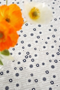 Macro detail of white cotton tablecloth with blue sunflower embroidery and striped texture
