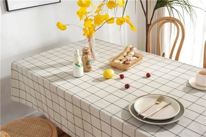 Detailed texture of beige and black checkered tablecloth with cotton fabric weaving