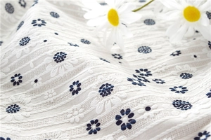 Macro detail of sunflower cotton jacquard fabric with delicate embroidery textures