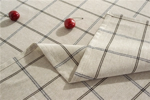 Close-up of classic checkered tablecloth with detailed hemmed edges and woven texture