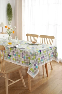 Detailed view of polyester-cotton tablecloth with colorful leaf patterns and lace edges