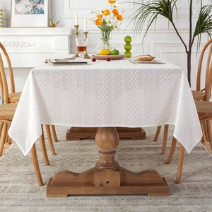 White French country lace tablecloth with hollow embroidery on a wooden dining table