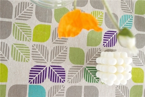 Detailed texture of polyester-cotton tablecloth featuring modern leaf geometric patterns