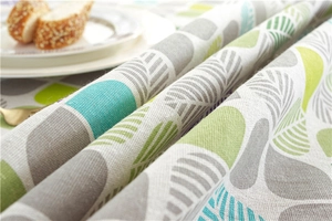 Detailed close-up of leaf pattern tablecloth with natural cotton linen twill texture