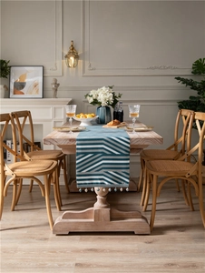 Detail of modern geometric jacquard table runner with decorative blue and white bead tassels
