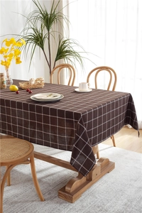 Detailed close-up showing the brown and white plaid texture of a cotton linen tablecloth