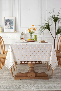 Close-up of cotton sunflower jacquard tablecloth with delicate white fringe tassels