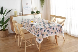 Detail of tropical palm leaf pattern tablecloth with white lace floral edge trim