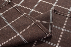Close-up of brown plaid cotton polyester tablecloth showing fine stitching and fabric texture