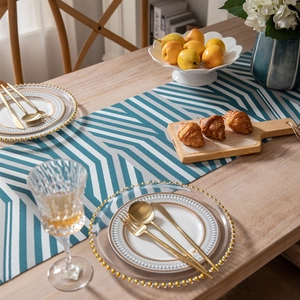Modern chenille table runner featuring blue and grey geometric herringbone patterns