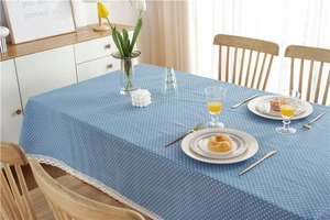 Close-up of blue polka dot tablecloth featuring elegant white lace edge embroidery