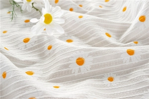 Close-up of white cotton sunflower jacquard fabric with delicate textured stripes