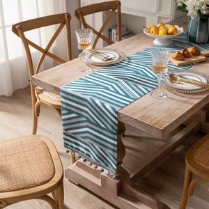 Modern jacquard chenille table runner with teal geometric chevron and beaded tassels