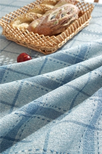 Close-up of blue plaid linen tablecloth fabric with natural texture and woven detail