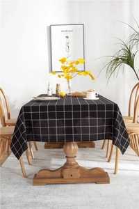 Detail of minimalist black and white checkered rectangular tablecloth with fine grid pattern