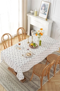 Detailed close-up of a floral cotton jacquard rectangular tablecloth with fringe edges