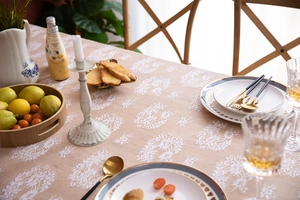 Detailed macro view of white lace floral patterns on oatmeal fabric tablecloth