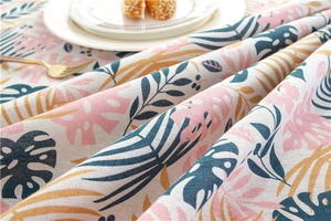 Detailed texture of polyester-cotton rose lace tablecloth with tropical leaf patterns