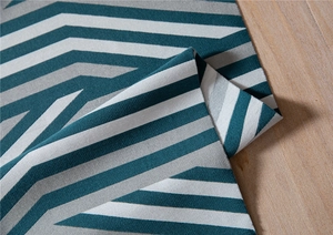 Detailed view of jacquard chenille fabric with modern teal and grey geometric patterns