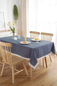 Close-up of blue tablecloth with white polka dots and elegant white lace borders