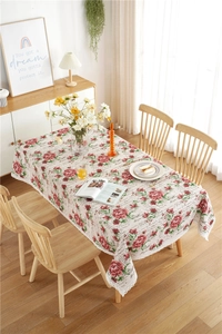 Close-up of vintage red rose pattern and delicate white lace edge on table cloth