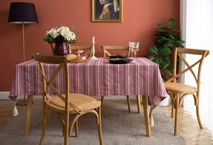 Detailed texture of bohemian striped tablecloth with white decorative tassels and fringe