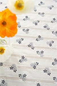 Close-up of rustic sunflower embroidery on beige cotton jacquard rectangular tablecloth