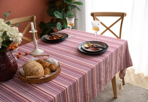 Close-up of Bohemian striped tablecloth with ethnic floral weave and heavy texture