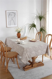 Close-up of waterproof polyester tablecloth with grey fern leaf pattern in a dining room