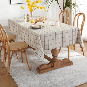 Minimalist beige plaid rectangle tablecloth made of cotton polyester on a wooden table
