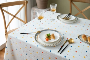 Detailed texture of white cotton tablecloth with colorful polka dots and jacquard weave